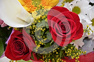 Beautiful bouquet of flowers in bright colors. It consists of roses, gerberas