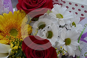 Beautiful bouquet of flowers in bright colors. It consists of roses, gerberas