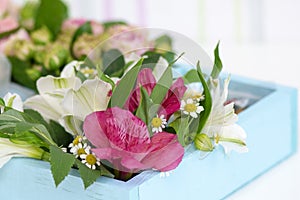 Beautiful bouquet of flowers decorated in a wooden box