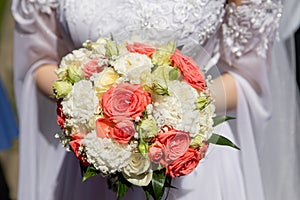 Beautiful bouquet of flowers in the hands of the bride