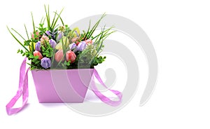 A beautiful bouquet of flowers made of natural soap in a pink paper gift box is isolated on a white background.space for