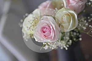 A Beautiful bouquet of flowers with white buds in black vase