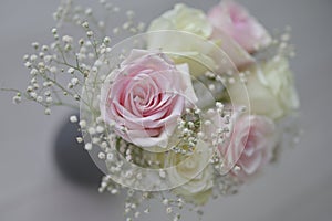 A Beautiful bouquet of flowers with white buds in black vase