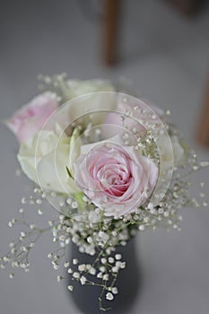 A Beautiful bouquet of flowers with white buds in black vase