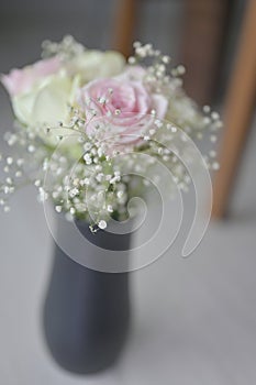 A Beautiful bouquet of flowers with white buds in black vase