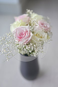 A Beautiful bouquet of flowers with white buds in black vase
