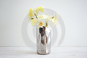 Beautiful bouquet of fresh yellow daffodil flowers in vase against white background. Spring blossoms. Mother`s day card