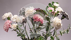Beautiful bouquet of pink, grey and white carnation flowers, fresh eucalyptusas and violet brassica flower
