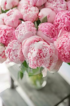 Beautiful bouquet of pink peonies . Floral composition, daylight. Wallpaper. Lovely flowers in glass vase.