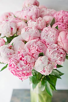 Beautiful bouquet of pink peonies . Floral composition, daylight. Wallpaper. Lovely flowers in glass vase.