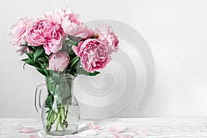 Beautiful bouquet of pink peony flowers in vase. womans day or wedding background with copy space