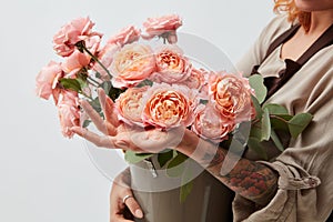 Bouquet with pink ranunculus in girl hands isolated on white background.