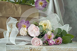 A beautiful bouquet of pink roses in a craft paper bag