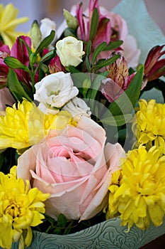 Beautiful bouquet with pink roses, yellow chrysanthemums and purple alstroemeria. Tender spring bouquet.