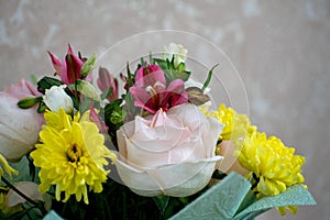 Beautiful bouquet with pink roses, yellow chrysanthemums and purple alstroemeria. Tender spring bouquet.