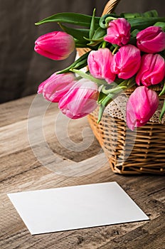 Beautiful bouquet of pink tulips and congratulations on the tabl