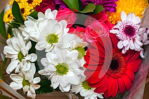 A beautiful bouquet of red gerberas, white chrysanthemums and red roses