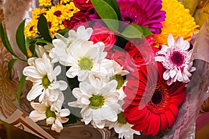 A beautiful bouquet of red gerberas, white chrysanthemums and red roses