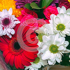 A beautiful bouquet of red gerberas, white chrysanthemums and red roses