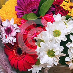 A beautiful bouquet of red gerberas, white chrysanthemums and red roses