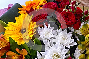 Beautiful bouquet with red roses, white chrysanthemums and gerberas.