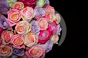 Beautiful bouquet of roses in a gift box. Bouquet of pink roses. Pink roses close-up. on black background, with space