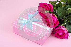 Beautiful bouquet of roses and gift box for holiday