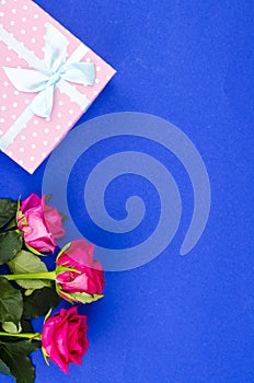 Beautiful bouquet of roses and gift box for holiday