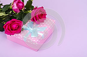 Beautiful bouquet of roses and gift box for holiday