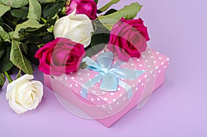 Beautiful bouquet of roses and gift box for holiday