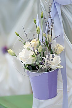 Beautiful bouquet of roses and lavender in bucke