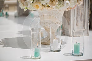 Beautiful bouquet of roses in a vase on a background of a wedding arch. Beautiful set up for the wedding ceremony.