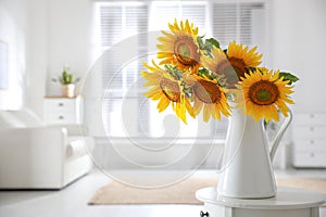 Beautiful bouquet of sunflowers in vase on table indoors. Space for text