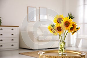 Beautiful bouquet of sunflowers in vase on table indoors. Space for text