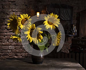 Beautiful bouquet of sunflowers in vase on a wooden table