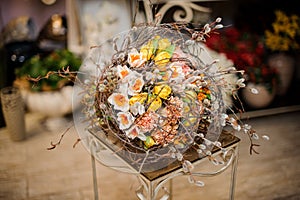 Beautiful bouquet of white, pink and yellow flowers decorated with willow branches