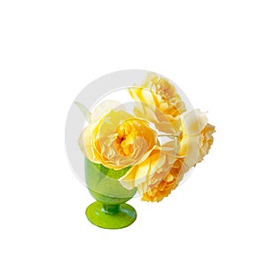 Beautiful bouquet of yellow roses in a green glass vase close-up. Soft selective focus. copy space. Isolated on a white