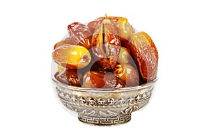 Beautiful bowl full of dates symbolizing Ramadan isolated on white background.