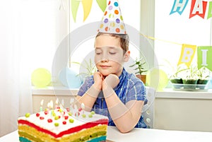 Beautiful boy in blue shirt, celebrating his birthday remotely