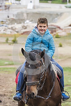 Beautiful boy and girl riding horses on the green meado photo