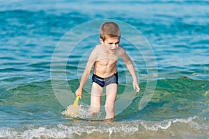 Beautiful boy playing with toys