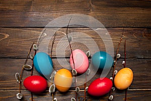 Beautiful branch of willow and easter eggs wood background