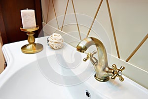 Beautiful brass faucet in retro and white sink