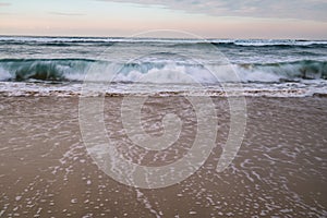 Beautiful breaking waves on sandy beach on atlantic ocean, basque country, france