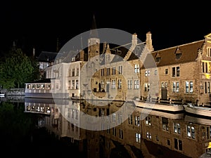 Beautiful brick architecture is reflected in the canal in front of RozenhoedKaai in the old city of Bruges, Belgium