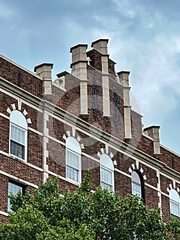 Beautiful brick building with five white stone columns on top