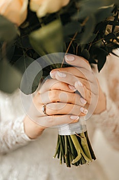 Beautiful bridal bouquet, bride with a wedding ring holding flowers in her hands