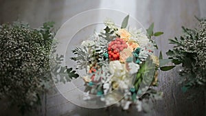 Beautiful bridal bouquet in glass vase stands amidst bridesmaid's flowers