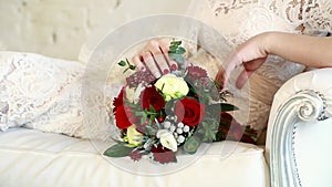 Beautiful bridal bouquet in hands of young bride dressed in white wedding dress. Close up of big bunch of fresh white