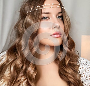 Beautiful bridal look, bride with long hair, wearing pearl tiara jewellery and beauty makeup, woman with curly hairstyle